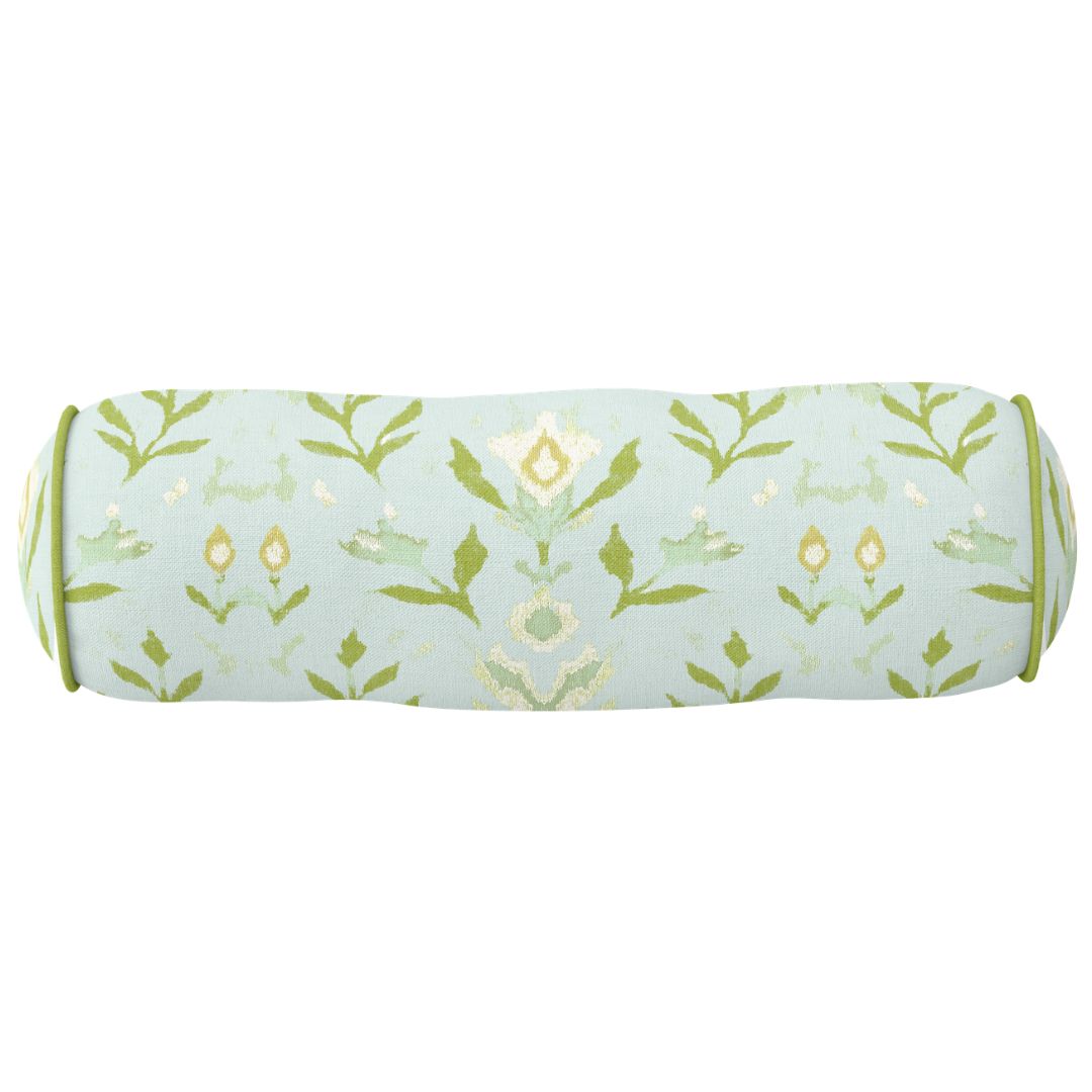 Round bolster pillow with Laura Park's Petal Garden Aqua, a hand painted design with blue, olive, and cream motifs with a green embroidered border to be styled in living rooms, guest rooms, bedrooms, sitting rooms, and dorms.