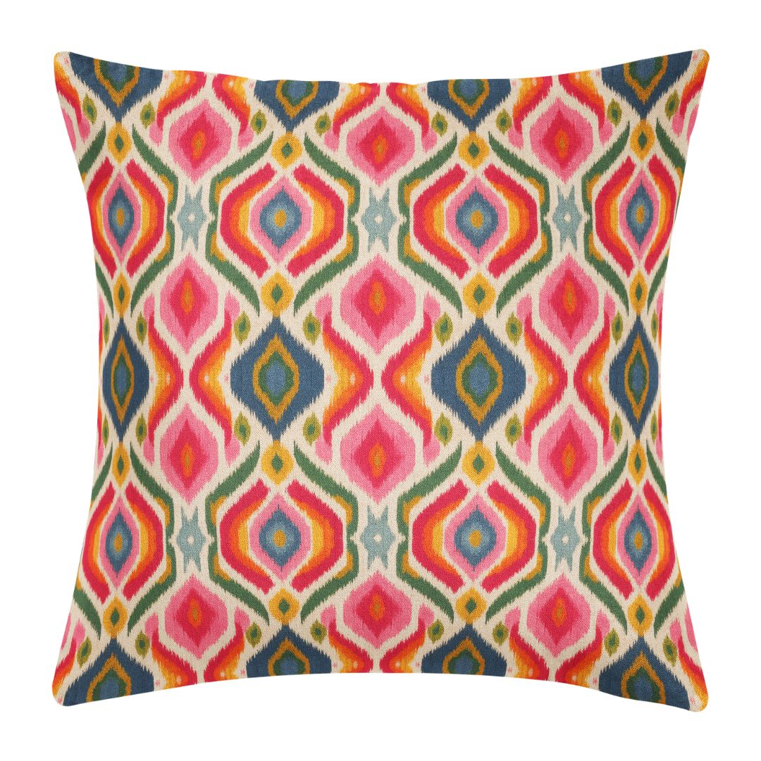 Bloomsbury Ikat Decorative Pillow by Laura Park featuring hand-painted ikat in reds, oranges, yellows, and pinks — living room — living room, bedroom, and sofa.