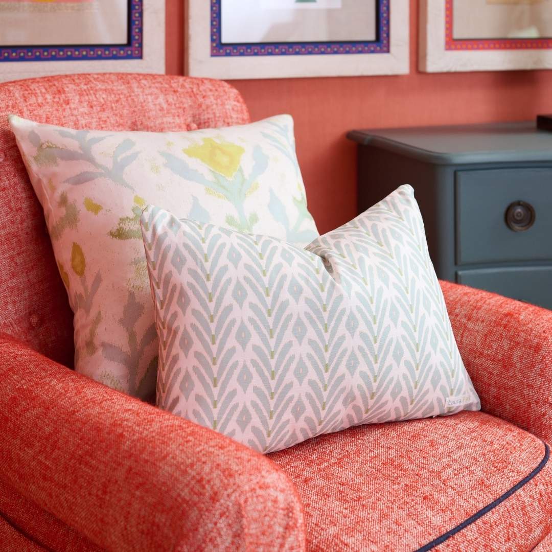 Petite Frond Blue Decorative Pillow by Laura Park featuring soft blue with subtle green accents, Laura Park's Petite Frond Blue Decorative Pillow is styled with the petite garden linen pillow on a red oversized accent armchair — perfect for.