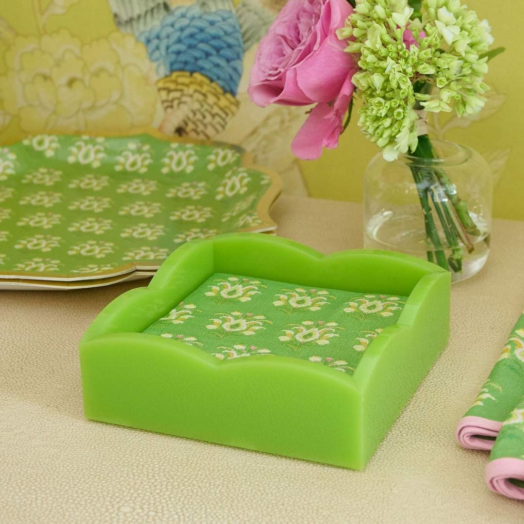 Laura Park paper cocktail napkins for entertaining and hosting in signature green painted floral pattern, rosemary meadow seen here on a green acrylic scalloped cocktail napkin holder seen with the laura park rosemary garden scalloped dinner.