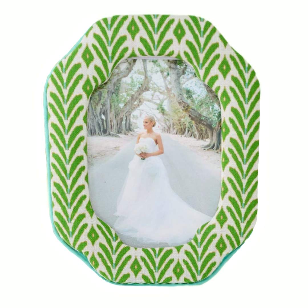 The Petite Frond Fabric Frame with ikat-inspired motif in bright green with subtle blue seen here with a bridal portrait inside the frame. 