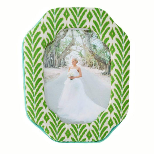 The Petite Frond Fabric Frame with ikat-inspired motif in bright green with subtle blue seen here with a bridal portrait inside the frame. 