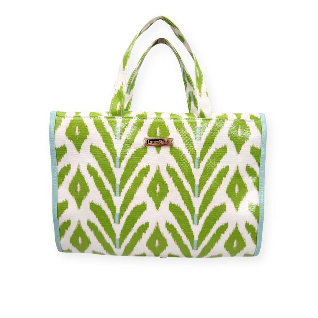 Green and white patterned travel hanging organizer bag with a wipeable inside lining and striped pockets with a blue outside lining and zipper. 