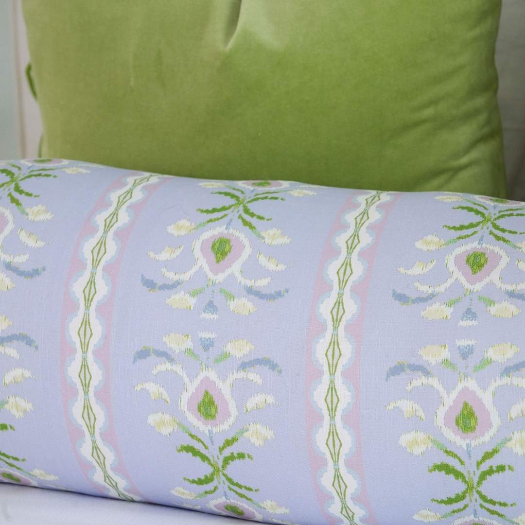 close up detail shot of the design of laura park's round bolster rosemary stripe lavender decorative pillow, perfect for pairing on beds and couches. 