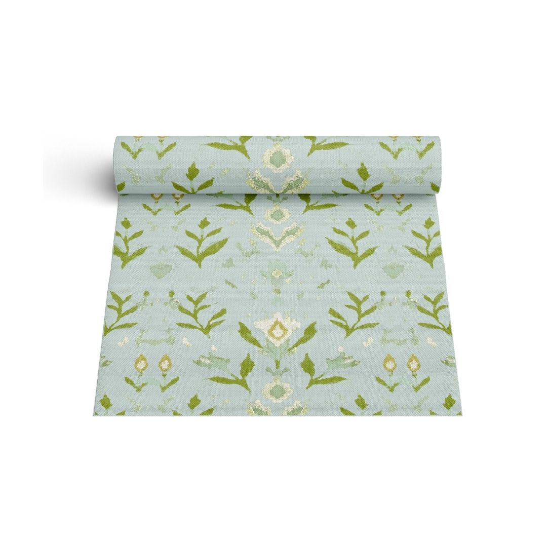 Laura Park's Signature painted pattern, petal garden aqua on a floor mat rug for indoor use in kitchen, bathroom, entry room, mud room, bedroom. Seen here in a mockup where the rug is rolled up. 