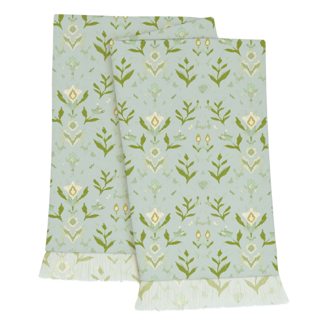 Laura Park's Petal Garden Aqua Throw Blanket, featuring hand-painted florals in shades of olive and light blue with a fringe edge, adding warmth and color to your bed, sofa, or favorite cozy spot.